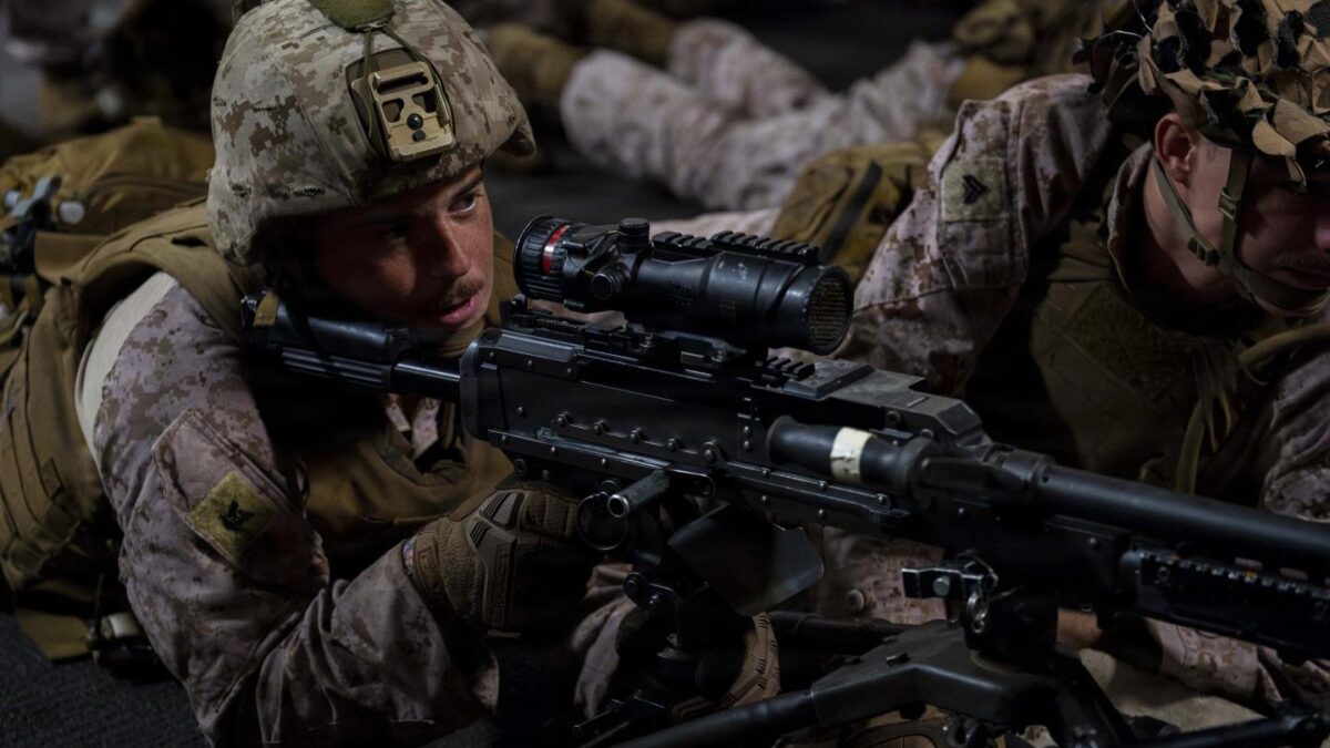 A U.S. sailor, assigned to Battalion Landing Team 3/5, 11th Marine Expeditionary Unit (MEU), participates in a live-fire drill using an M240B machine gun in the upper vehicle deck of Wasp-class amphibious assault ship USS Boxer (LHD 4), July 15, 2026.