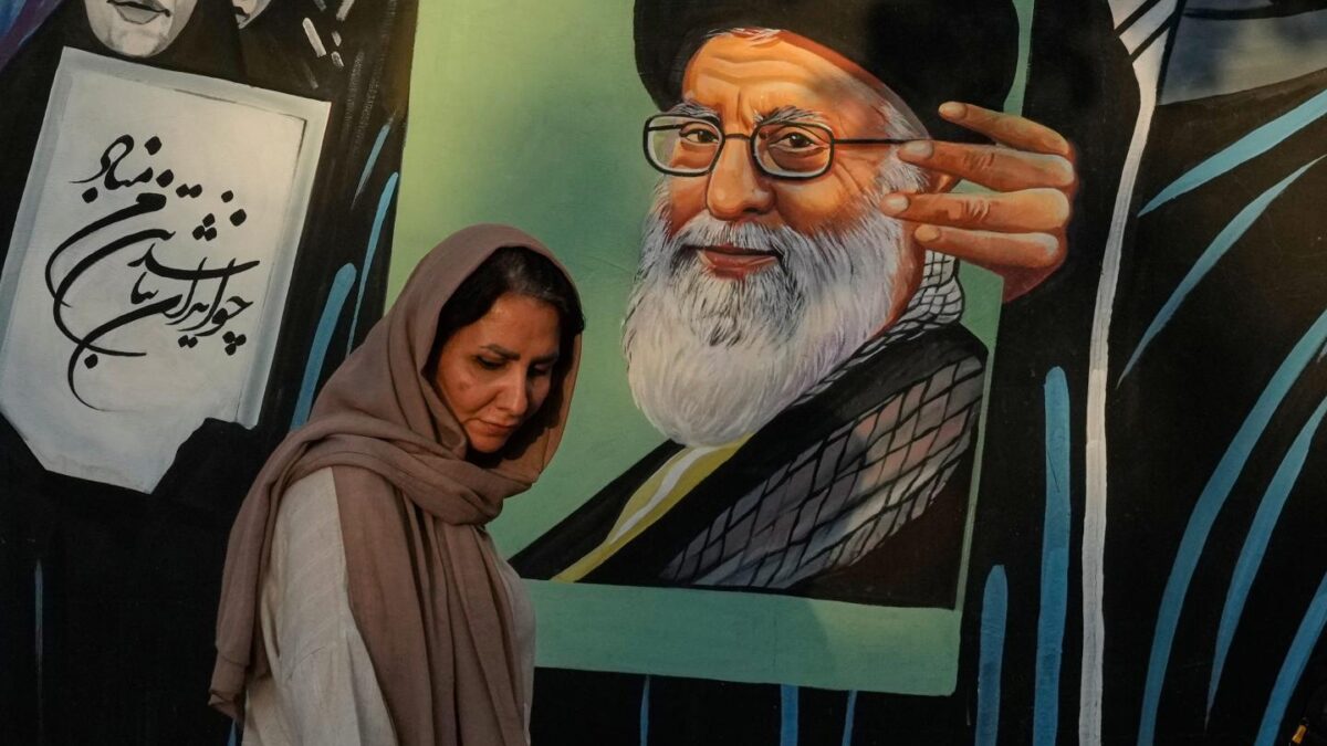 A woman walks past a mural depicting a portrait of the late Iranian Supreme Leader Ayatollah Ali Khamenei, who was killed in the U.S. and Israel strike on Feb. 28, in downtown Tehran, Iran, Saturday, July 18, 2026.
