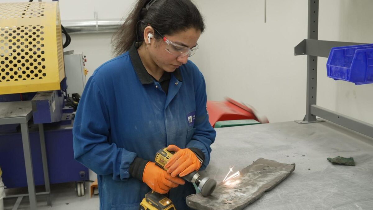Photo of worker polishing rare earth metal ingot