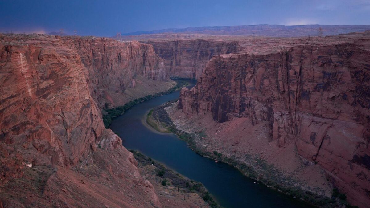 The Colorado River flows near the Glen Canyon Dam, July 15, 2026, near Page, Ariz.
