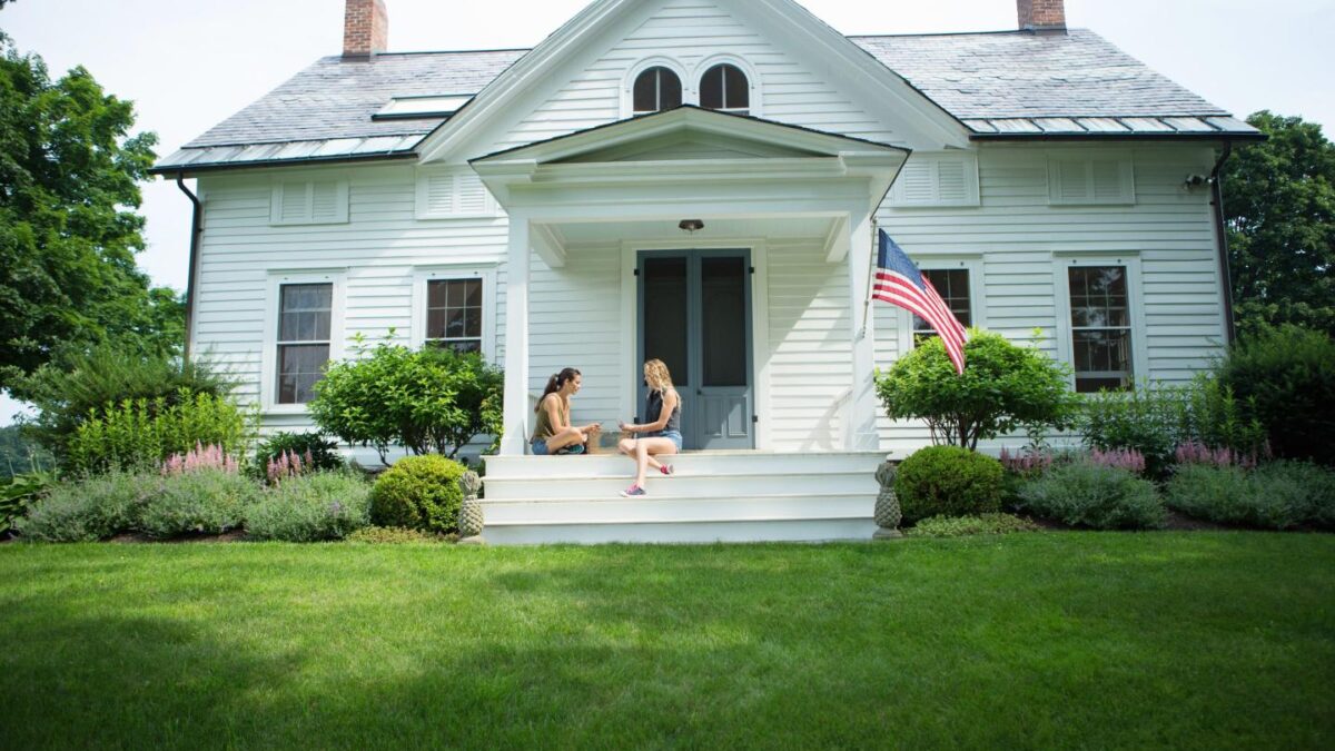 Sisters sitting on a porch