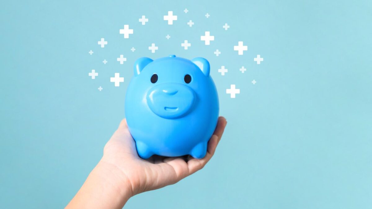 A person holding a blue piggy bank