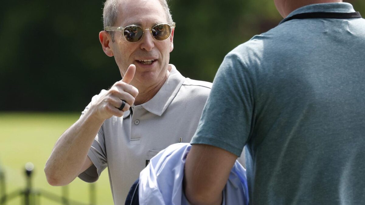Man in a polo shirt gives a thumbs up
