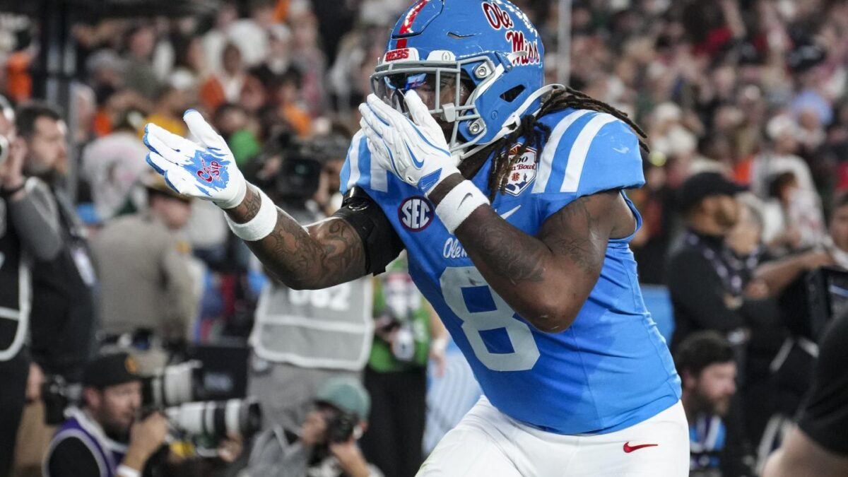 Dae'quan Wright #8 of the Ole Miss Rebels celebrates against the Miami Hurricanes during the second half of CFP Semifinal Vrbo Fiesta Bowl at State Farm Stadium.