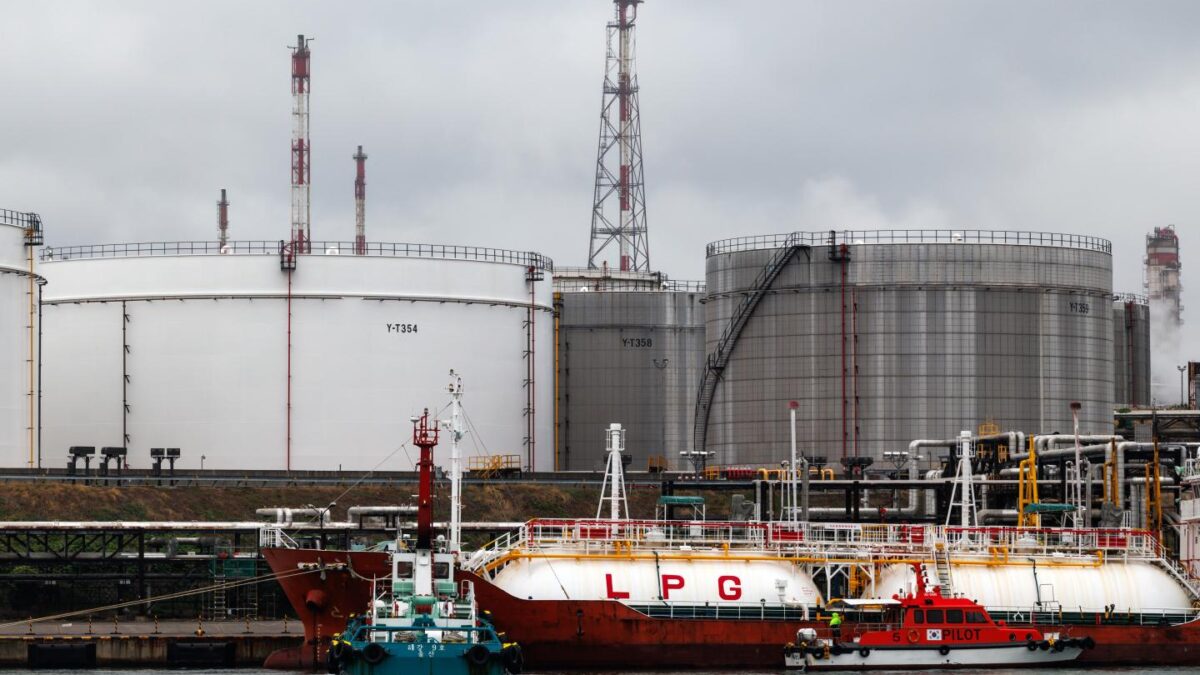 A liquefied petroleum gas (LPG) tanker in front of oil tanks at the SK Innovation Co. Ulsan Complex oil refinery facilities at dawn in Ulsan, South Korea, on Wednesday, June 24, 2026.