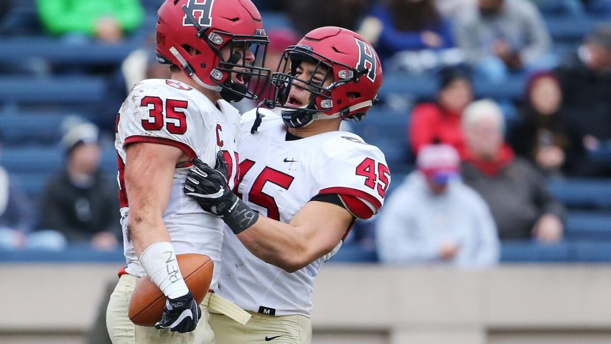 Photo of two Harvard football teammates at the Harvard v. Yale game